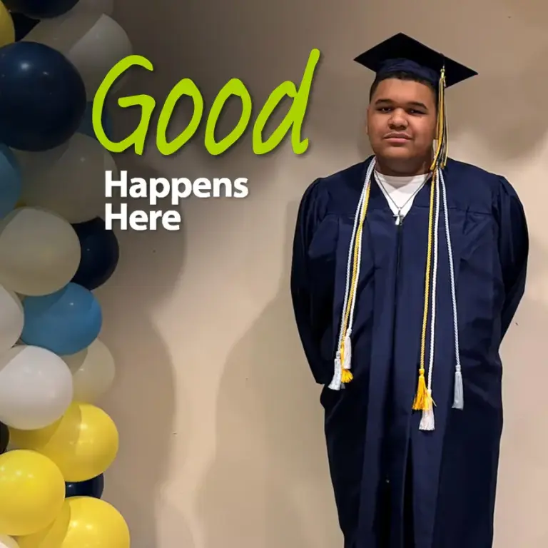 Shad posing in graduation cap and gown