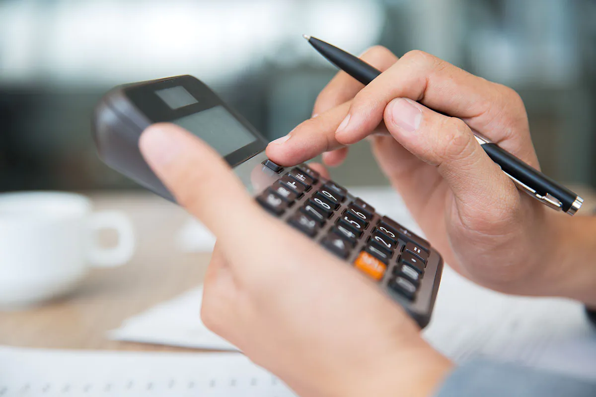 Fingers tapping on a calculator