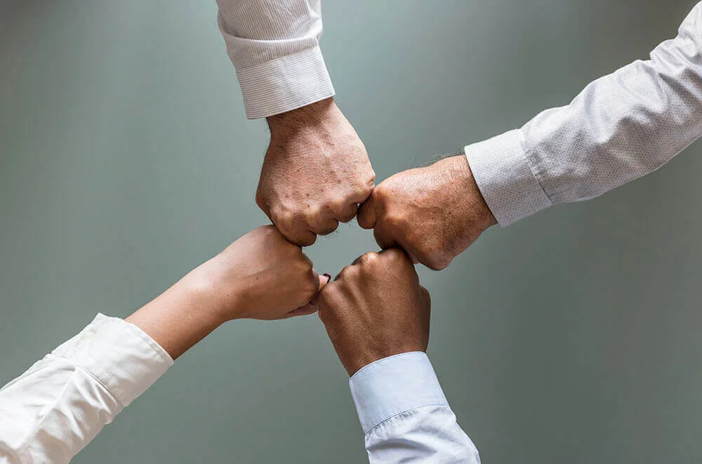 Team members fist-bumping.